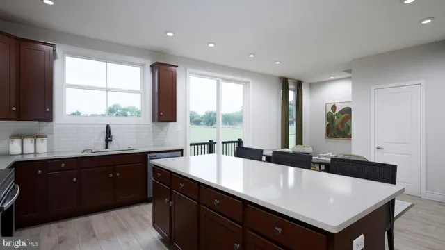 a kitchen with a sink a window and cabinets