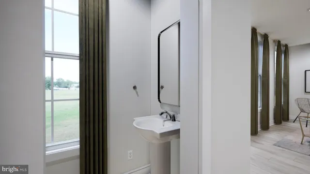 a bathroom with a sink a mirror and a window