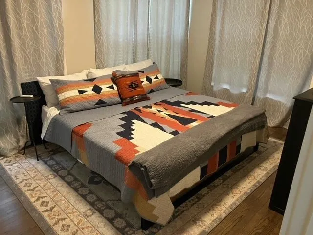 a bed sitting in a bedroom next to a window