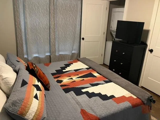 a bedroom with a bed and flat screen tv