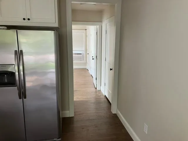 a view of a hallway with wooden floor