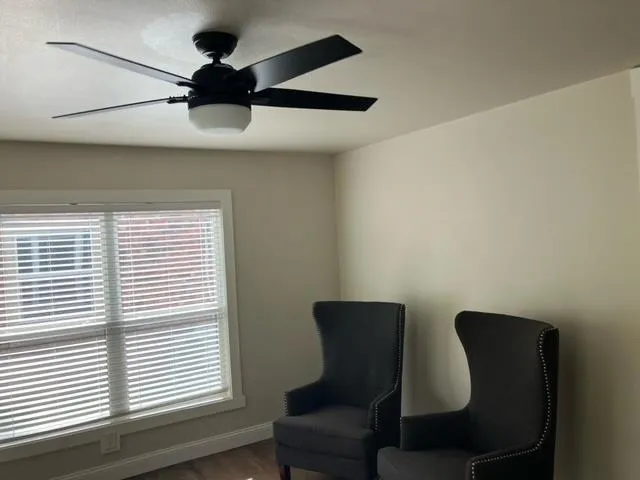 a view of a dining room with furniture and a window