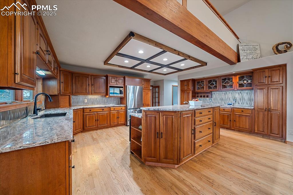 8045 Eagle Road Larkspur, CO 80118 - Photo 14 of 50 a kitchen with stainless steel appliances granite countertop a stove and a wooden floors