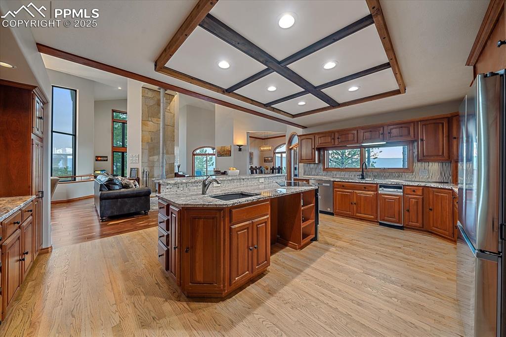 8045 Eagle Road Larkspur, CO 80118 - Photo 15 of 50 a large kitchen with stainless steel appliances sink and cabinets