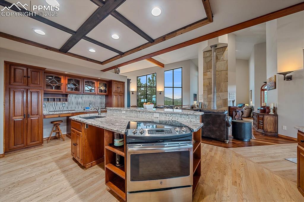8045 Eagle Road Larkspur, CO 80118 - Photo 16 of 50 a kitchen with stainless steel appliances granite countertop a stove and a refrigerator