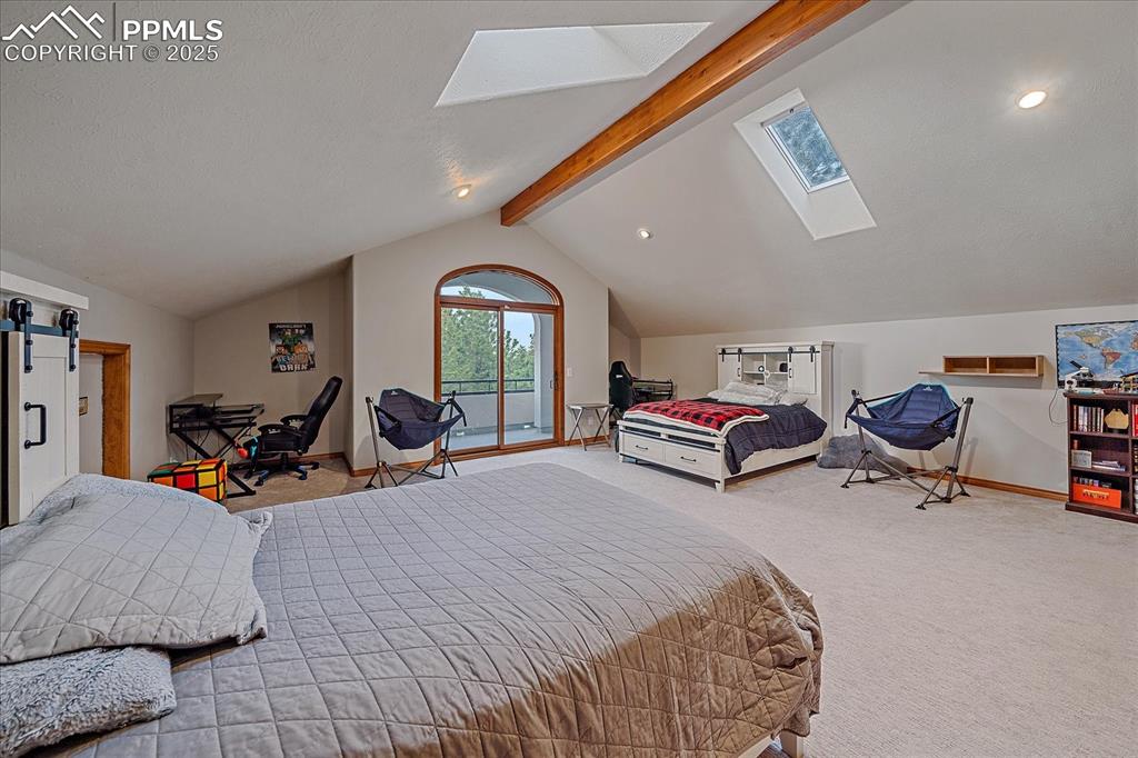 8045 Eagle Road Larkspur, CO 80118 - Photo 26 of 50 a bed room with a bed and a chair