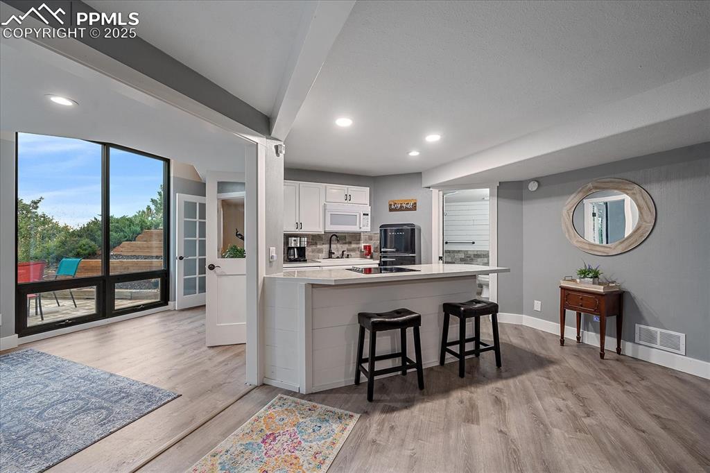 8045 Eagle Road Larkspur, CO 80118 - Photo 29 of 50 a living room with stainless steel appliances granite countertop furniture wooden floor and a rug