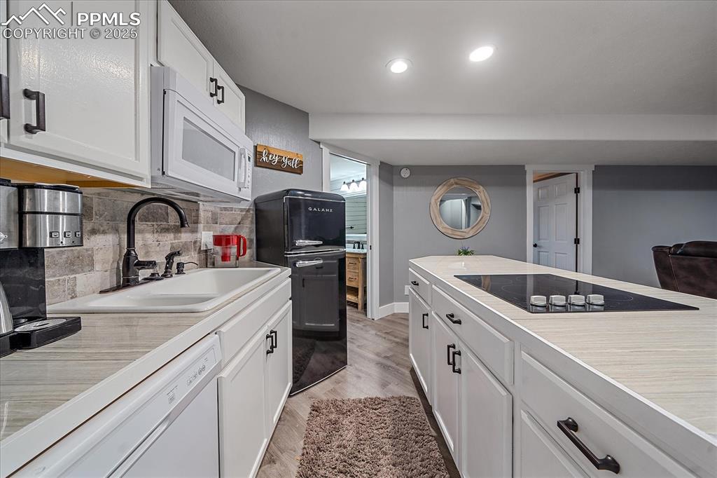 8045 Eagle Road Larkspur, CO 80118 - Photo 31 of 50 a kitchen with stainless steel appliances granite countertop a sink and cabinets