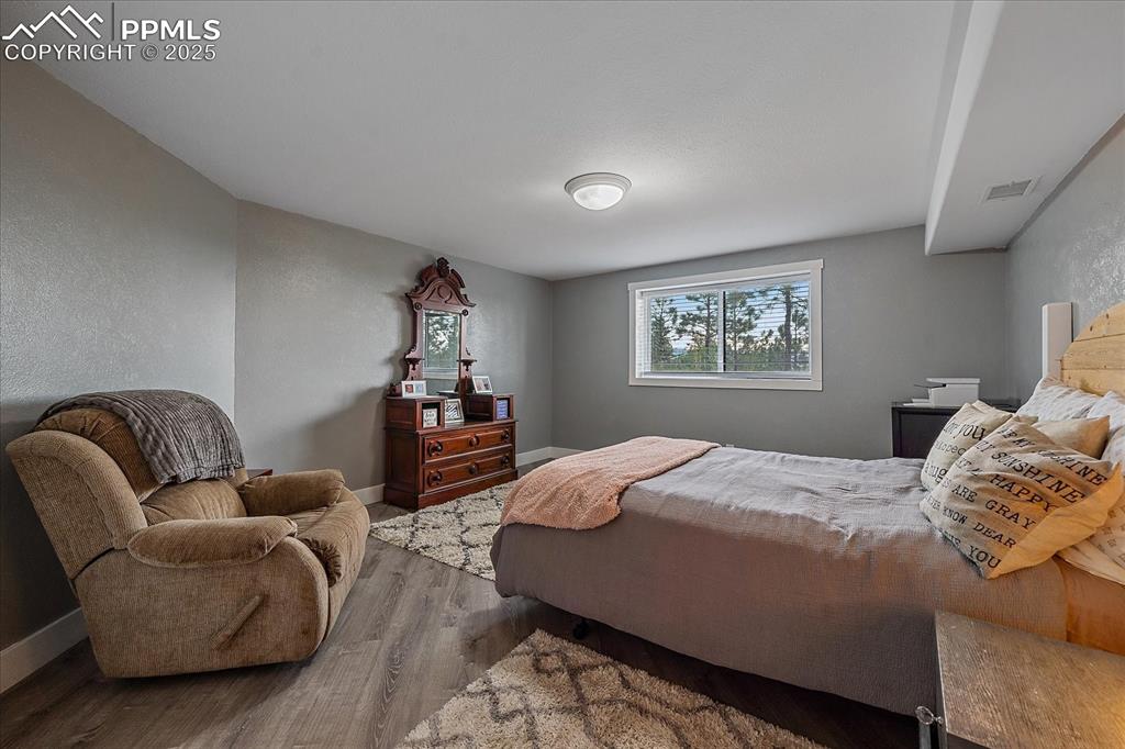 8045 Eagle Road Larkspur, CO 80118 - Photo 33 of 50 a bedroom with a bed couch and a window