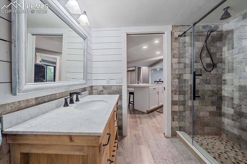 8045 Eagle Road Larkspur, CO 80118 - Photo 35 of 50 a bathroom with a sink shower and a mirror