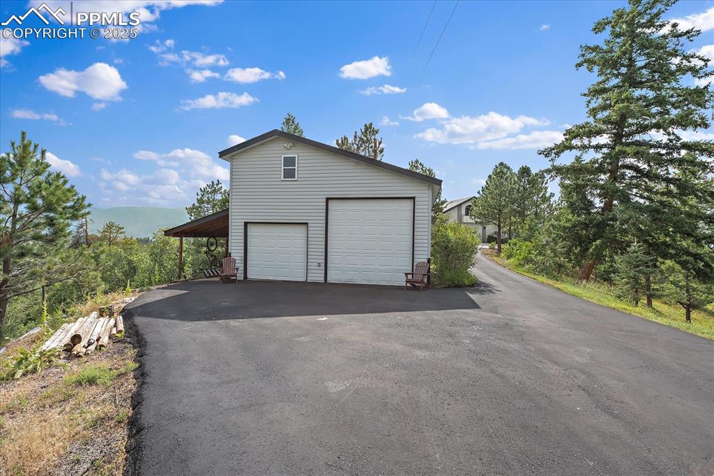 8045 Eagle Road Larkspur, CO 80118 - Photo 39 of 50 a view of a house with a yard and garage