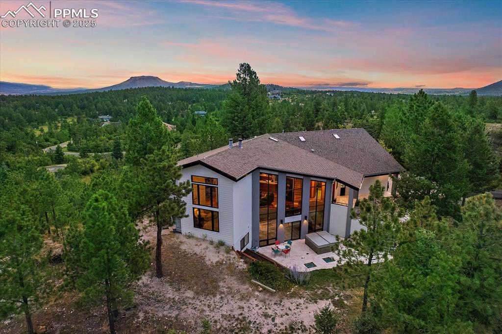8045 Eagle Road Larkspur, CO 80118 - Photo 40 of 50 a view of a house with a garden