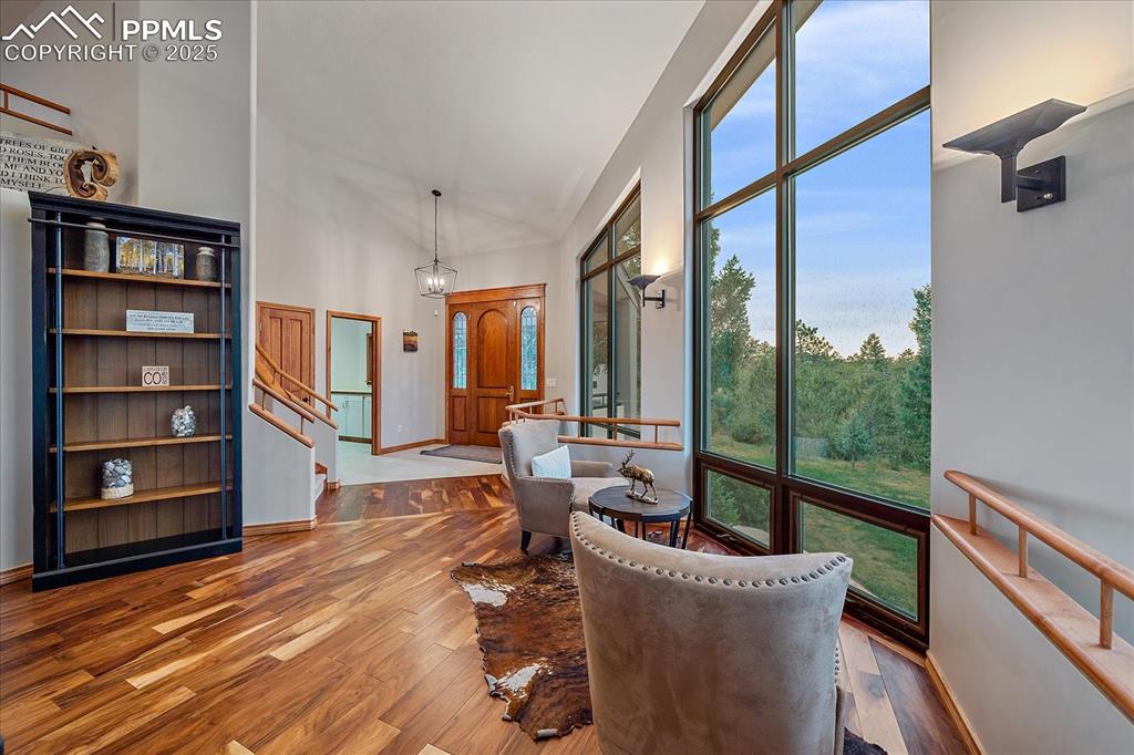 8045 Eagle Road Larkspur, CO 80118 - Photo 4 of 50 a living room with furniture wooden floor and a floor to ceiling window