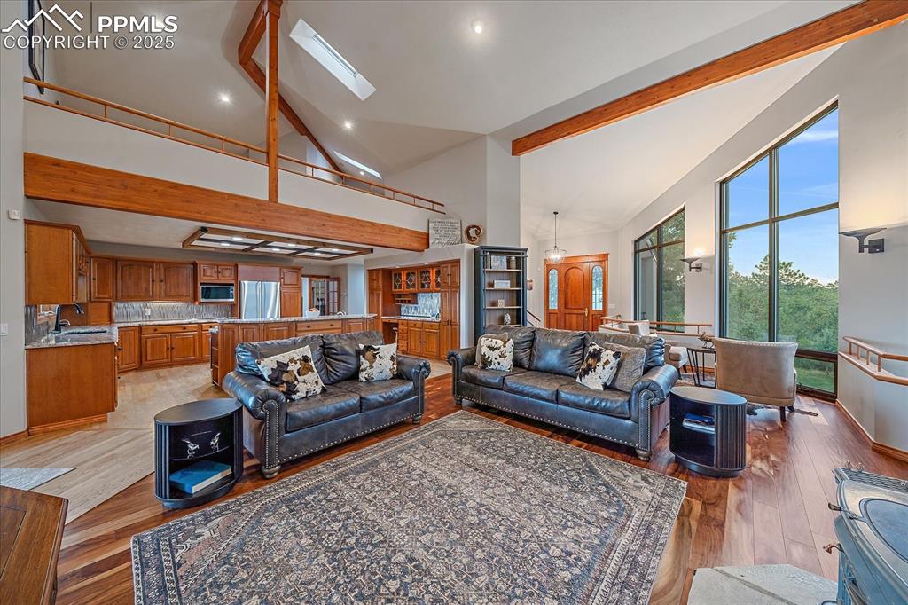 8045 Eagle Road Larkspur, CO 80118 - Photo 8 of 50 a living room with furniture ceiling fan and a rug