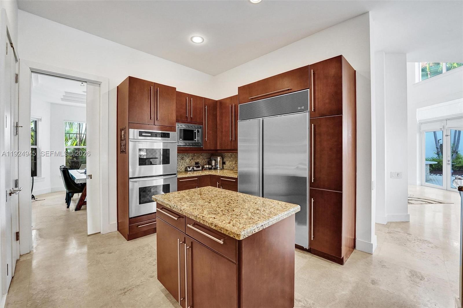 1575 Windjammer Way Hollywood, FL 33019 - Photo 13 of 42 a kitchen with a refrigerator a sink and a refrigerator