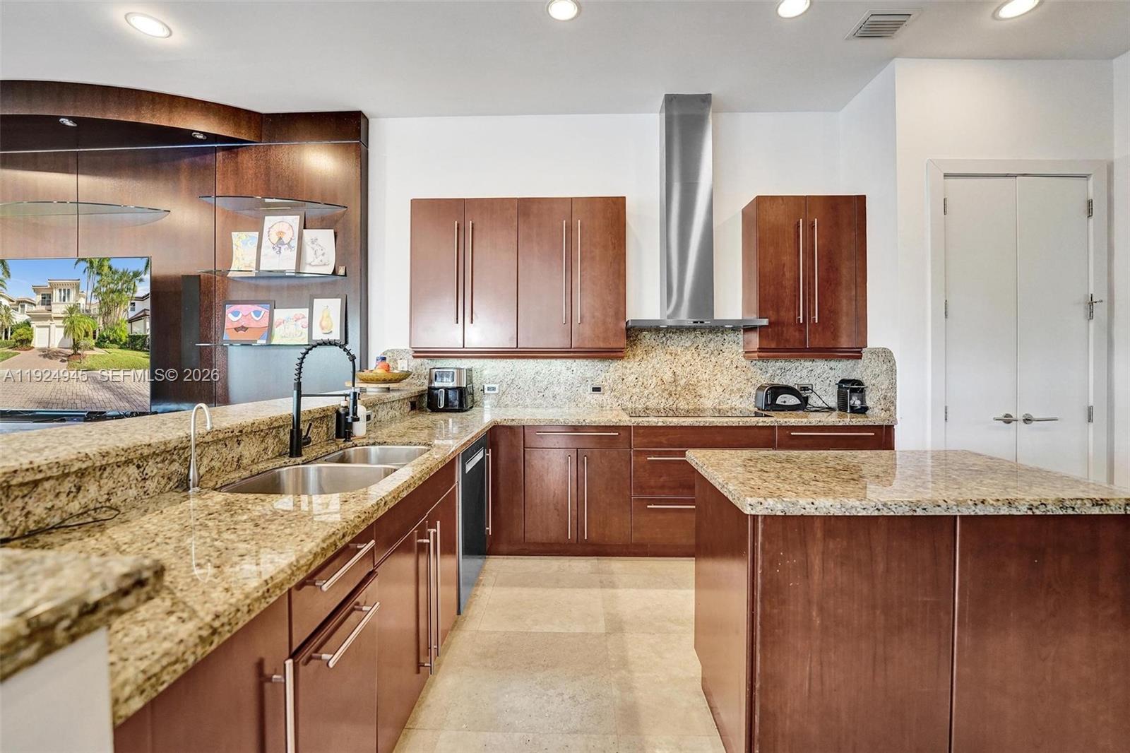 1575 Windjammer Way Hollywood, FL 33019 - Photo 15 of 42 a kitchen with granite countertop a sink a stove and cabinets