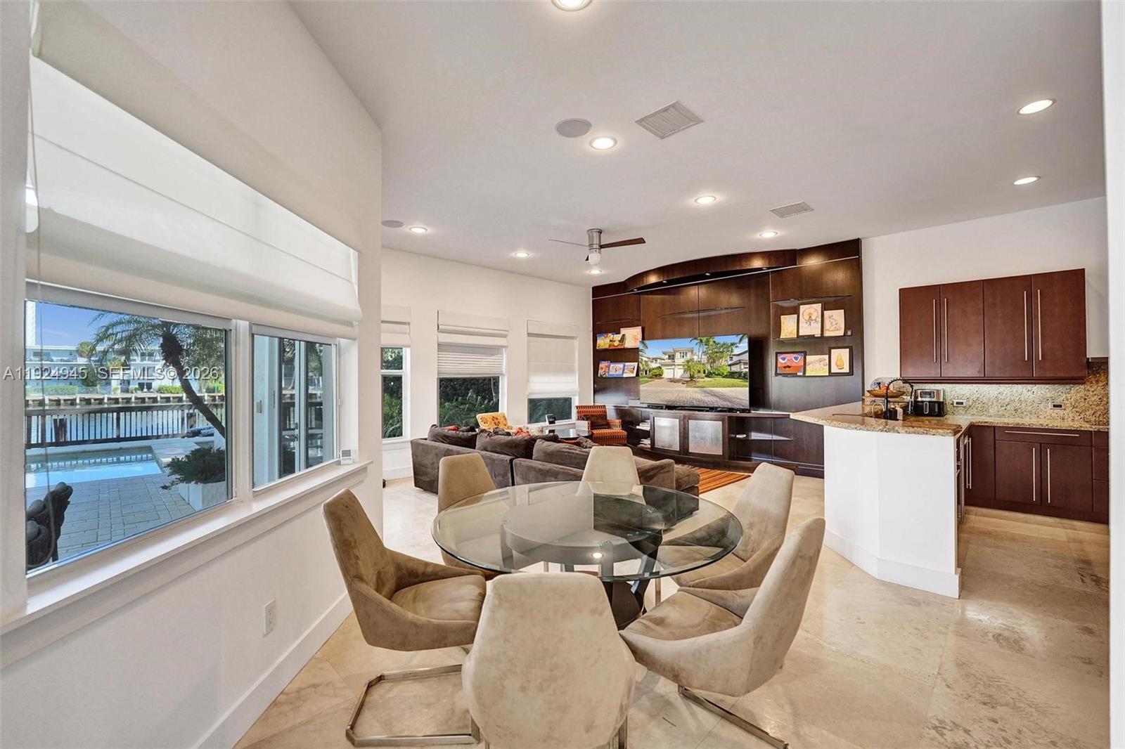 1575 Windjammer Way Hollywood, FL 33019 - Photo 16 of 42 a living room with fireplace furniture and a large window