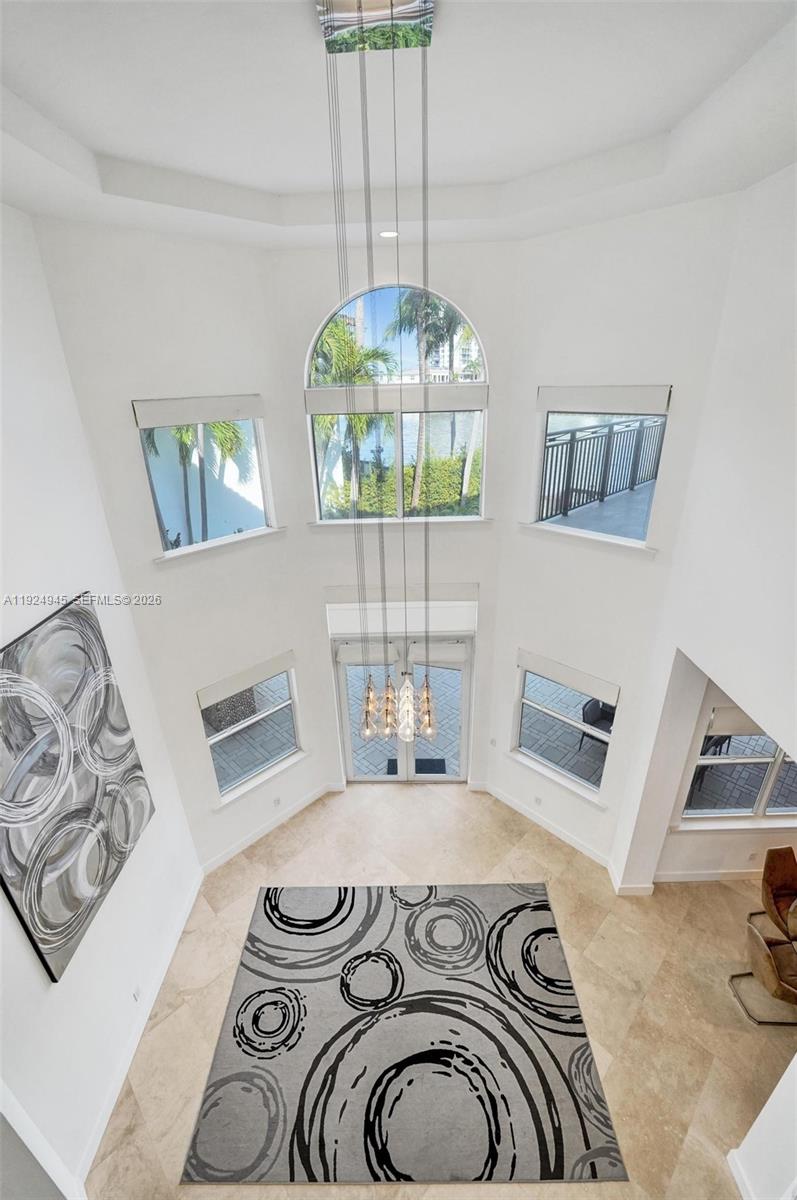 1575 Windjammer Way Hollywood, FL 33019 - Photo 20 of 42 a bedroom with a bed and a chandelier