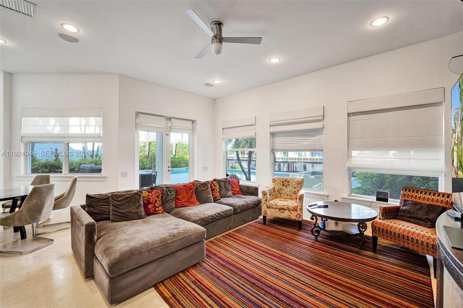 1575 Windjammer Way Hollywood, FL 33019 - Photo 23 of 42 a living room with furniture and large windows