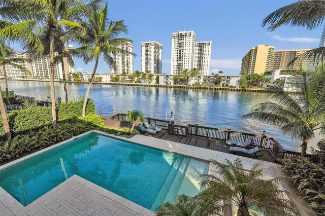 a view of a swimming pool with a lawn chairs