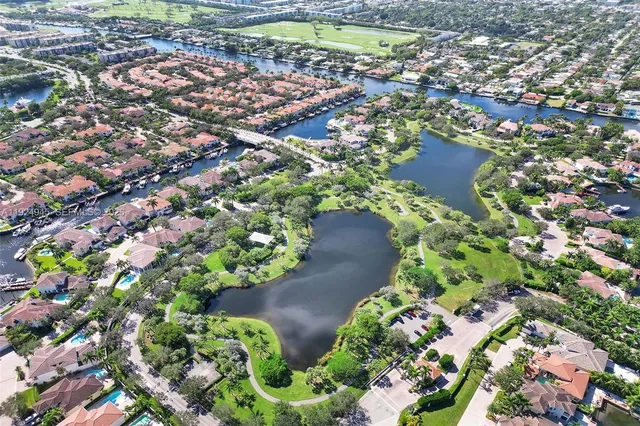 an aerial view of a houses with a yard
