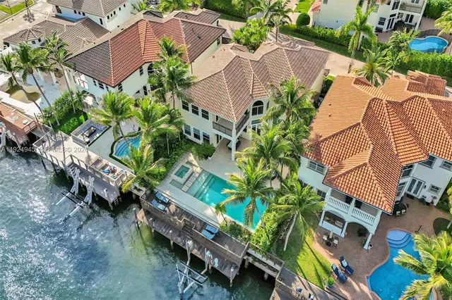 an aerial view of a house with a yard and plants