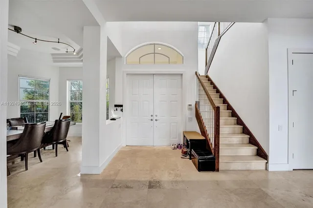 a view of entryway and hall with wooden floor
