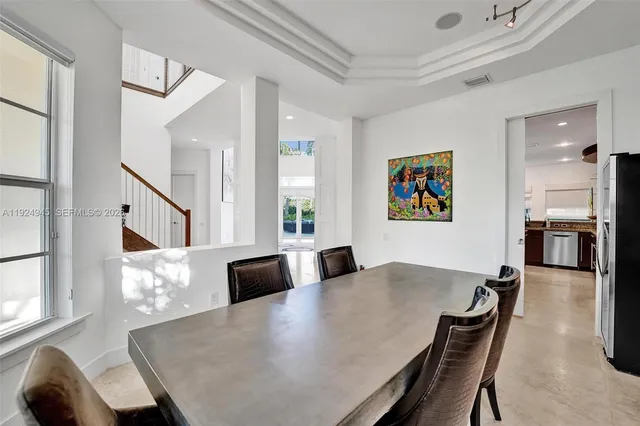 a view of a dining room with furniture and a large window