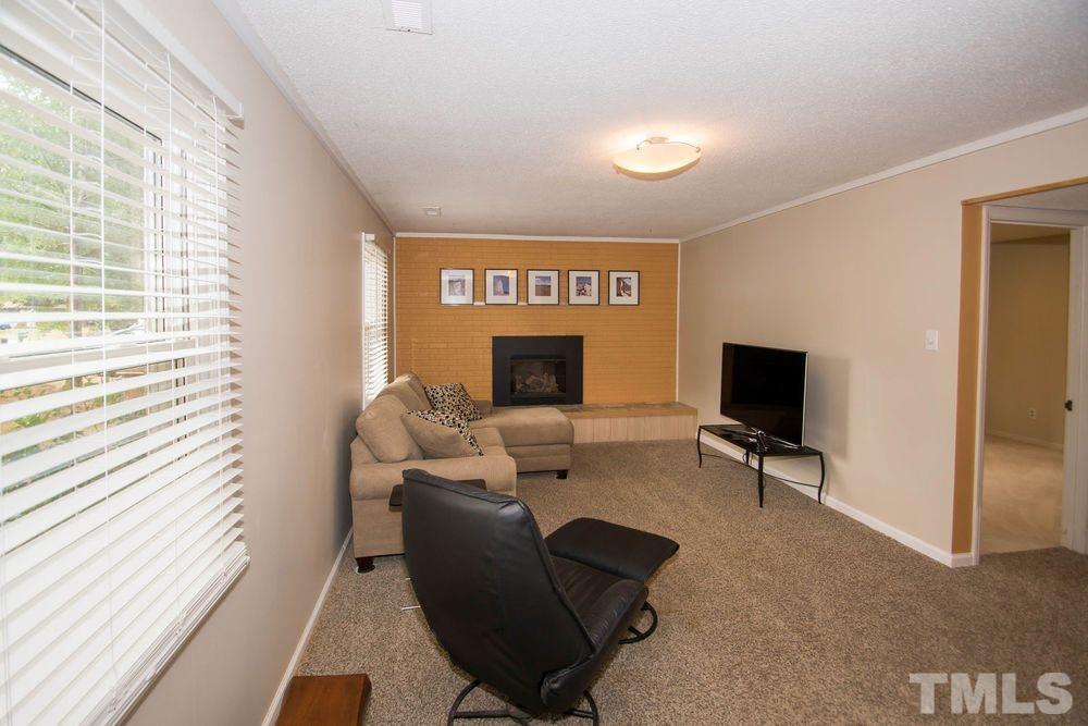 708 Merwin Road Raleigh, NC 27606 - Photo 11 of 25 a living room with furniture and a flat screen tv