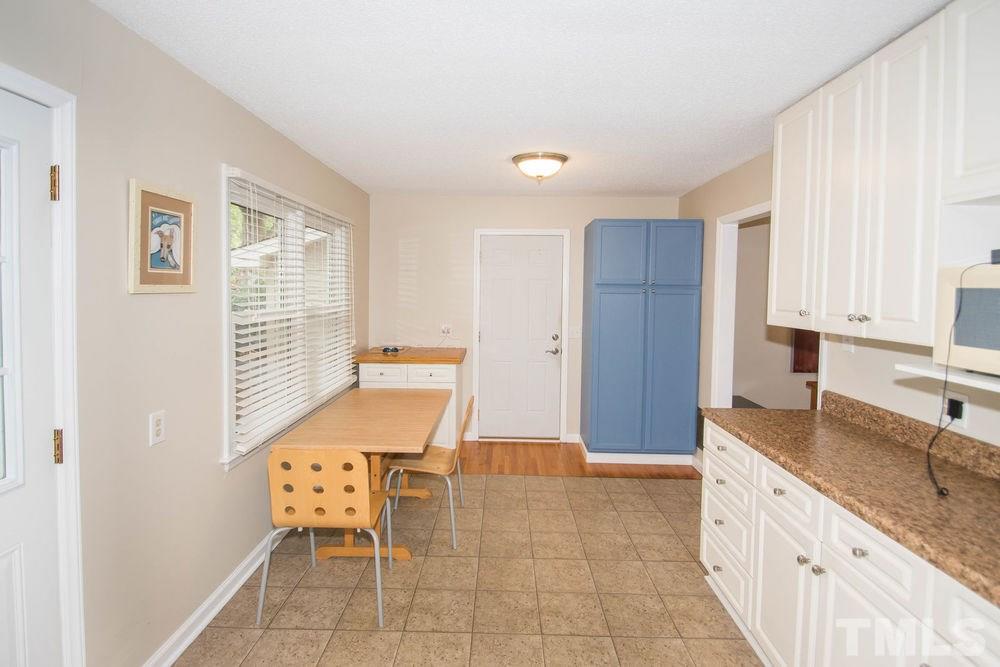 708 Merwin Road Raleigh, NC 27606 - Photo 12 of 25 a room with granite countertop furniture a sink and a window