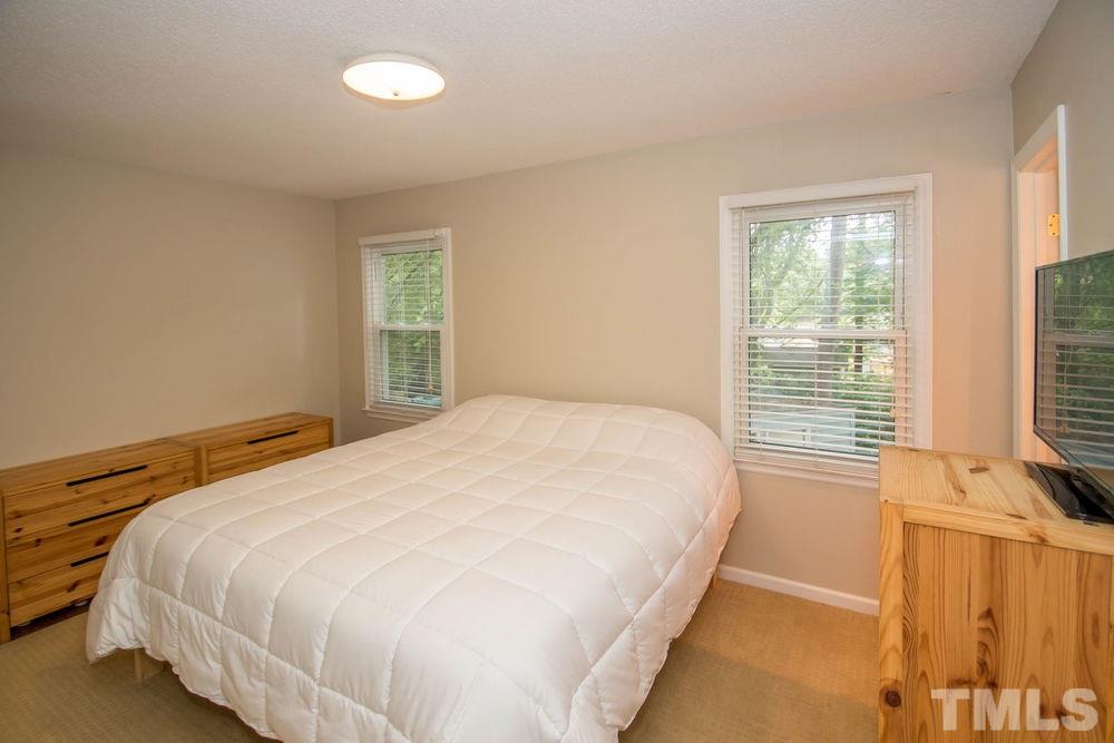 708 Merwin Road Raleigh, NC 27606 - Photo 17 of 25 a bedroom with a bed and a window