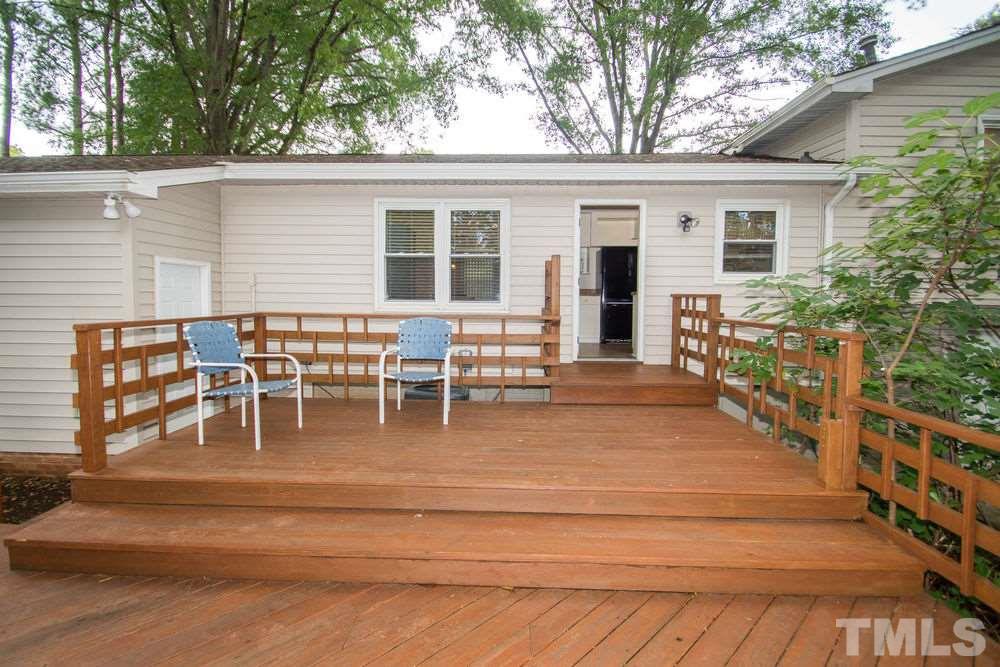 708 Merwin Road Raleigh, NC 27606 - Photo 20 of 25 a view of a patio with table and chairs potted plants and large tree