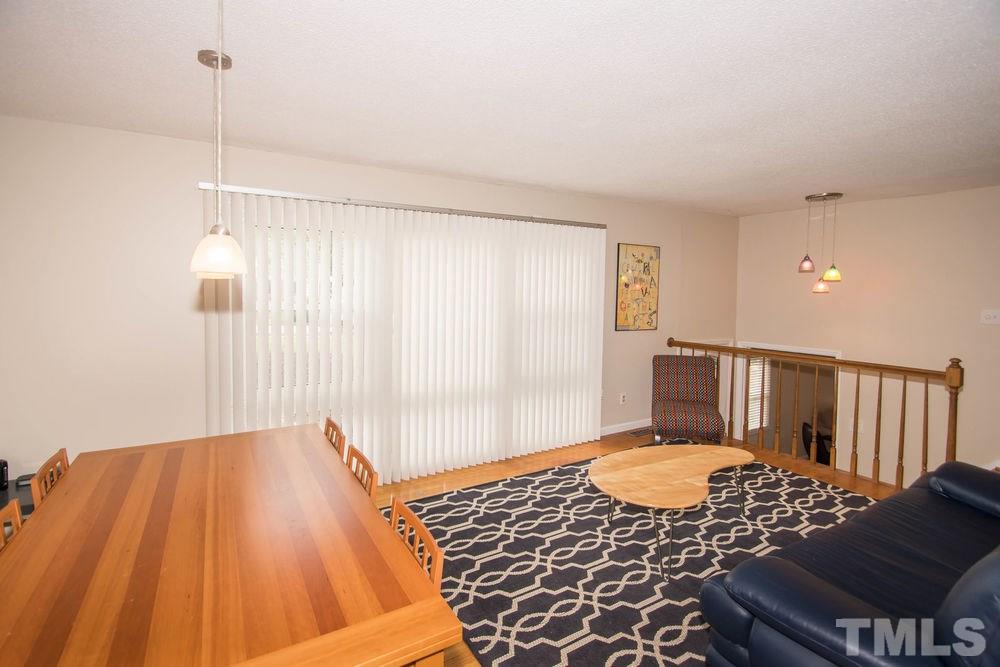 708 Merwin Road Raleigh, NC 27606 - Photo 4 of 25 a bedroom with a bed and wooden floor