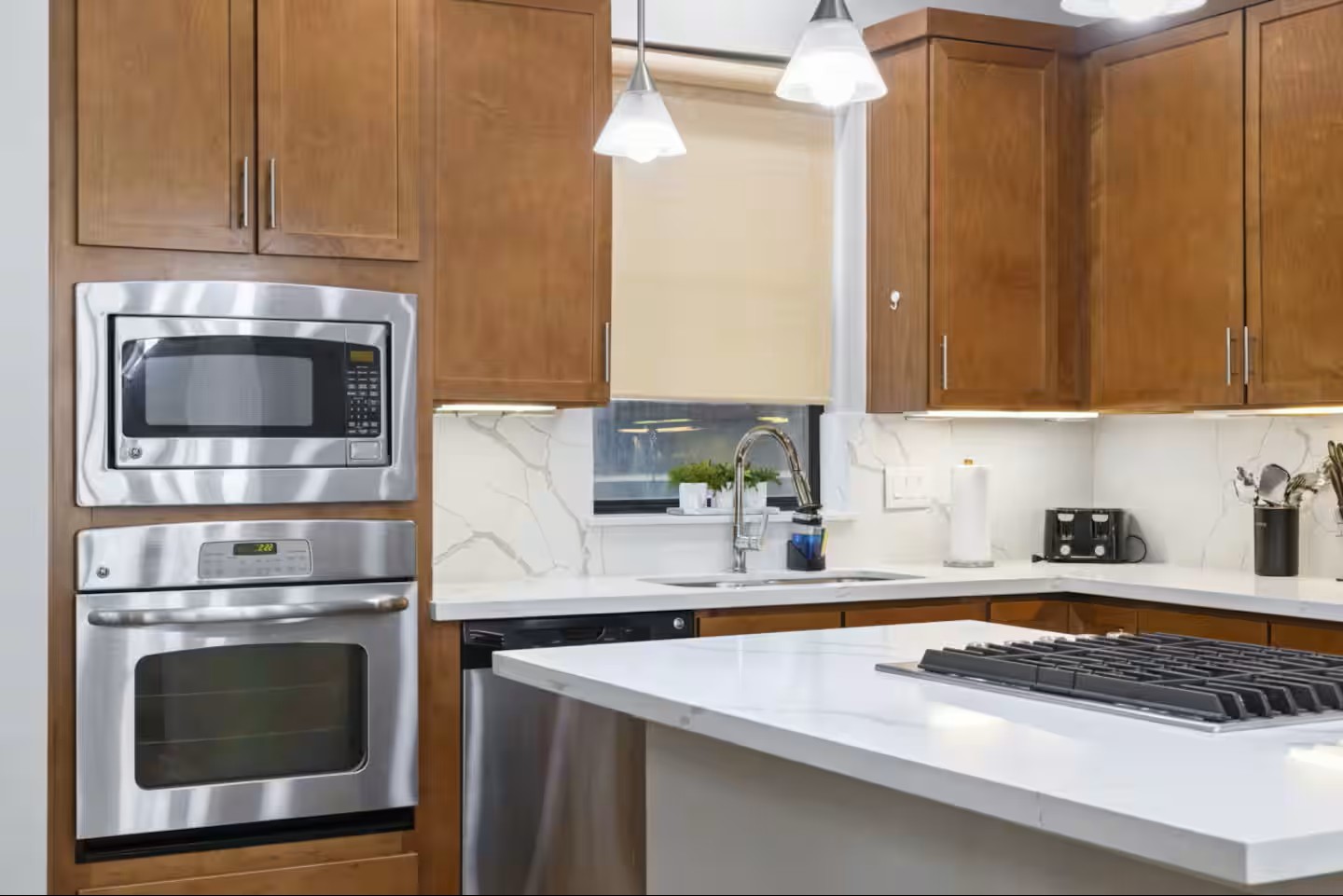 1205 Detering Street Houston, TX 77007 - Photo 10 of 30 a kitchen with stainless steel appliances a stove a microwave and sink