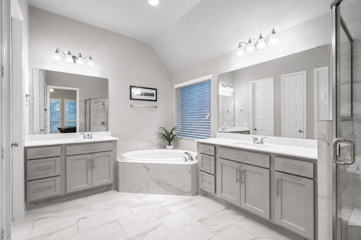 29118 Lantana Ridge Court Fulshear, TX 77441 - Photo 15 of 29 Step into a spa inspired primary bathroom showcasing a large soaking tub, modern double vanities, and beautiful tile flooring, a serene retreat that blends luxury, comfort, and timeless design.