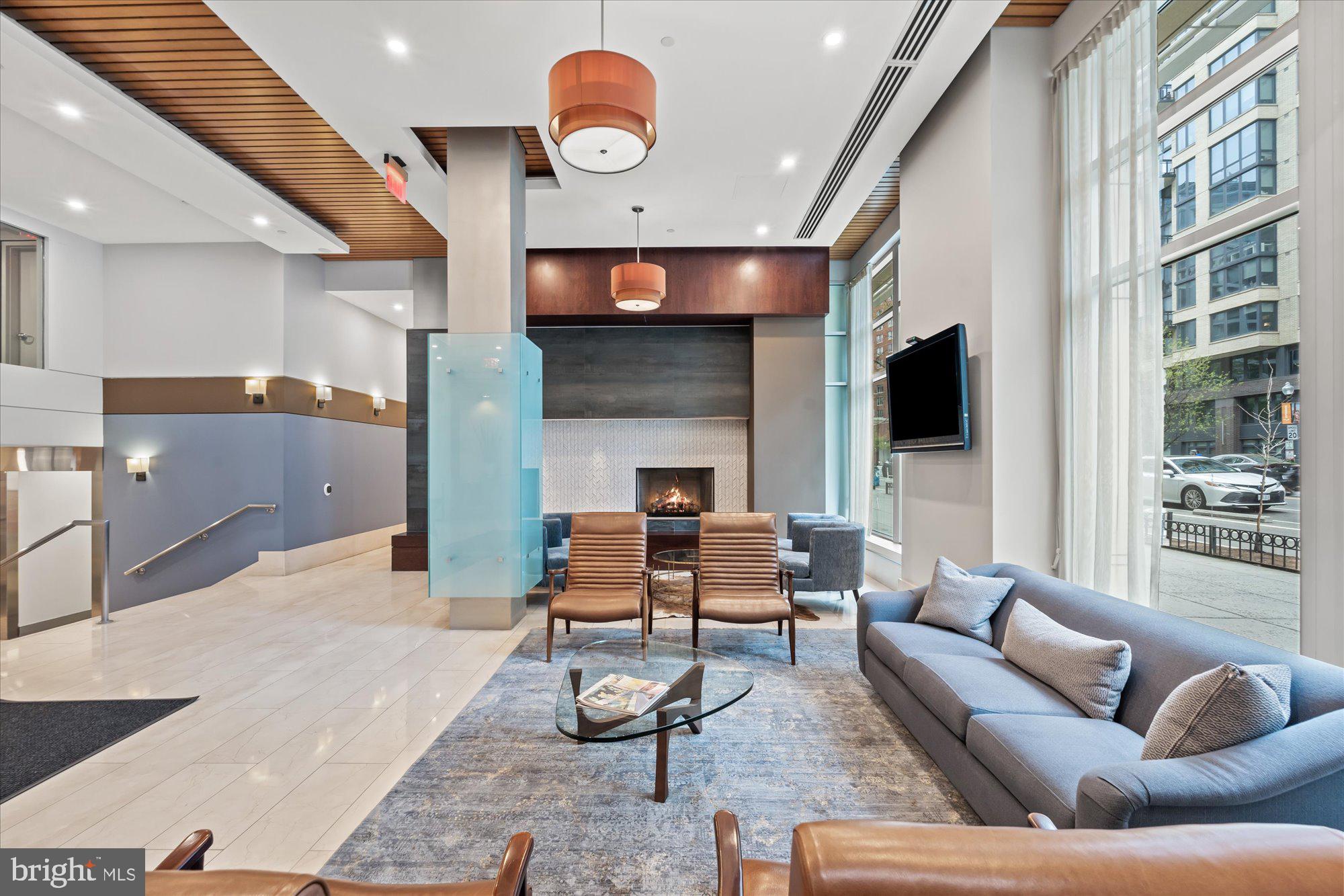 1025 First Street Southeast, Unit 511 Washington, DC 20003 - Photo 17 of 25 a living room with fireplace furniture and a flat screen tv