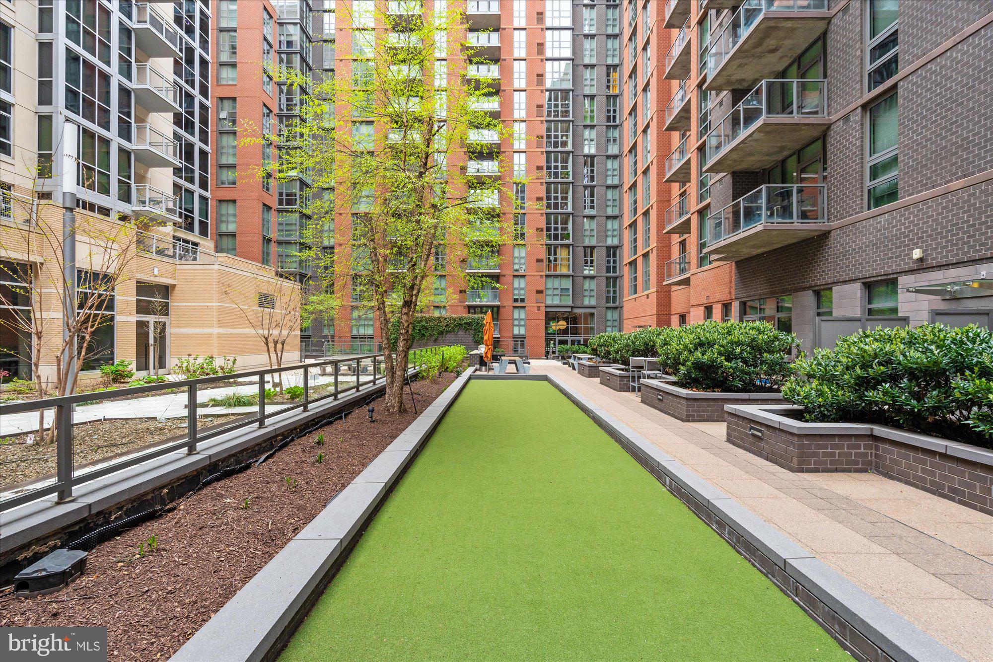 1025 First Street Southeast, Unit 511 Washington, DC 20003 - Photo 21 of 25 a swimming pool with outdoor seating and yard