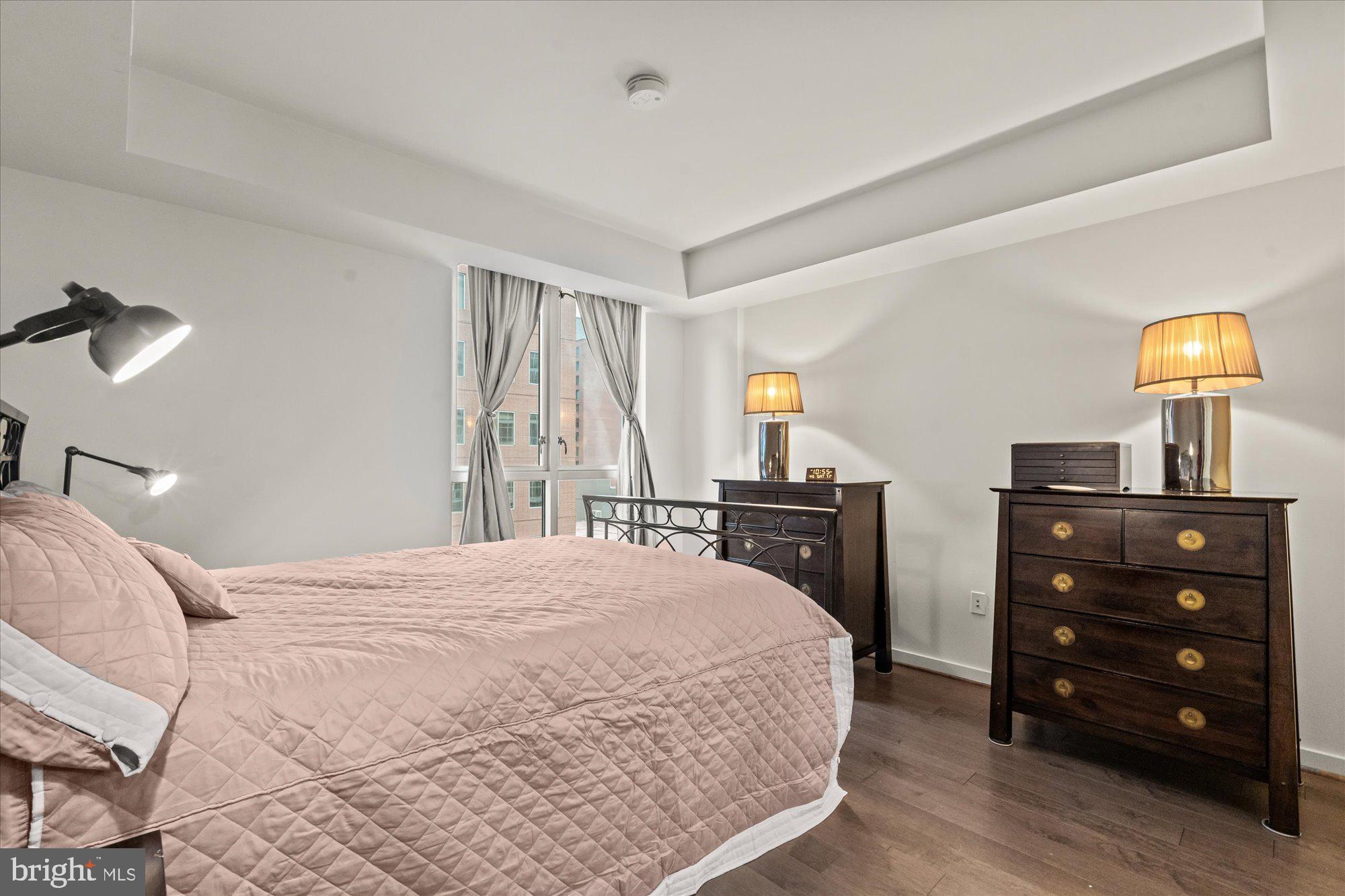 1025 First Street Southeast, Unit 511 Washington, DC 20003 - Photo 8 of 25 a bedroom with a bed and a tv