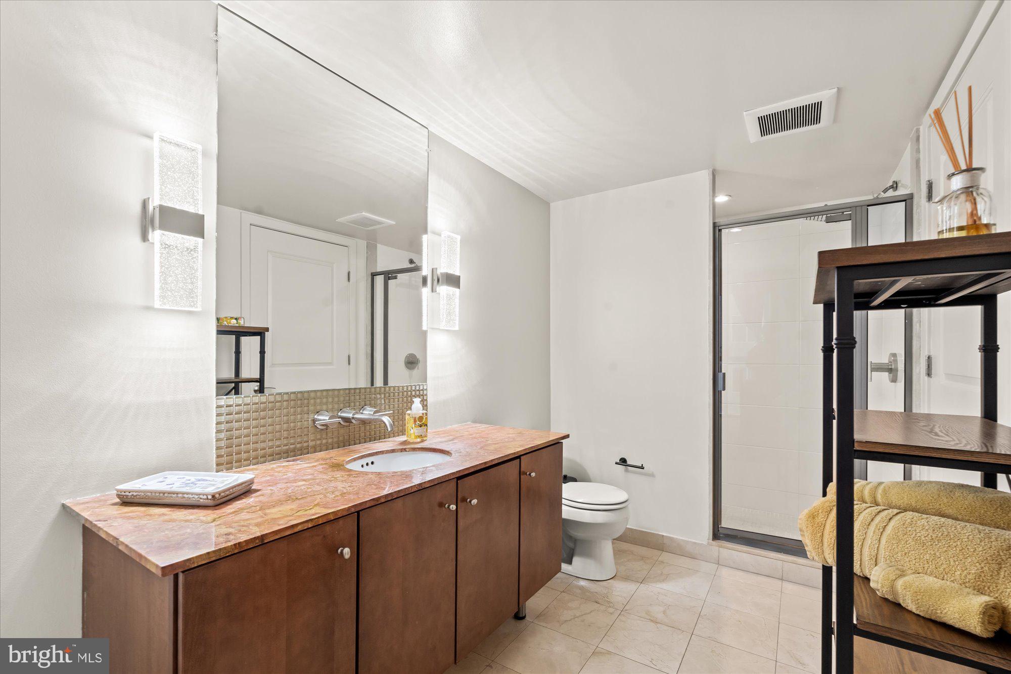 1025 First Street Southeast, Unit 511 Washington, DC 20003 - Photo 9 of 25 a bathroom with a sink a toilet and a mirror