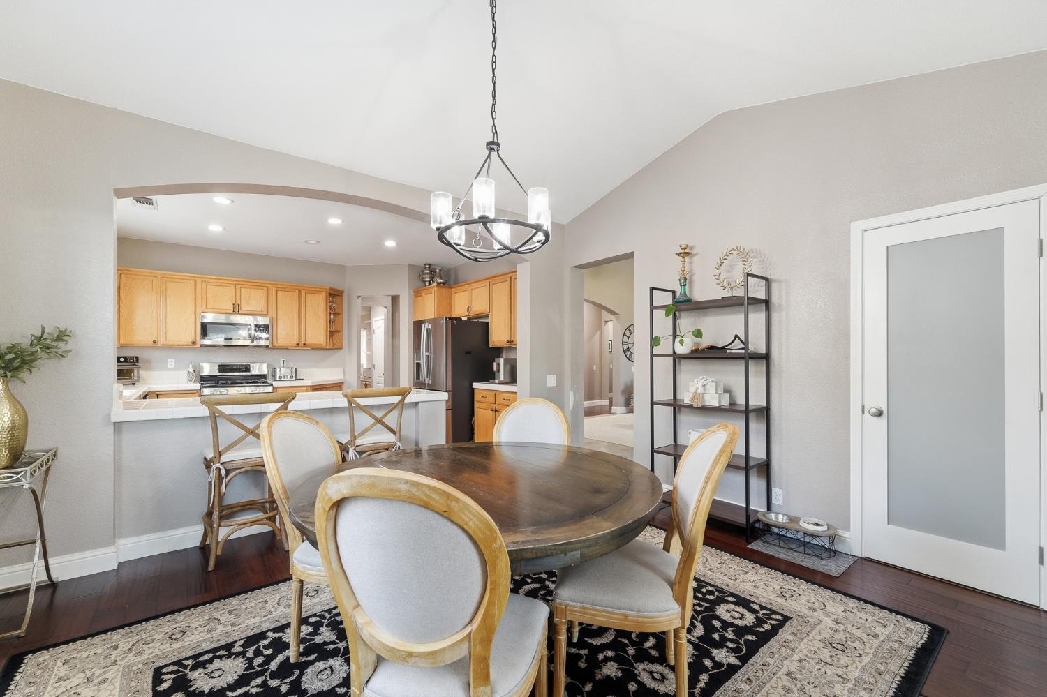 2220 Ellison Drive Modesto, CA 95355 - Photo 17 of 53 a dining room with wooden floor and a chandelier