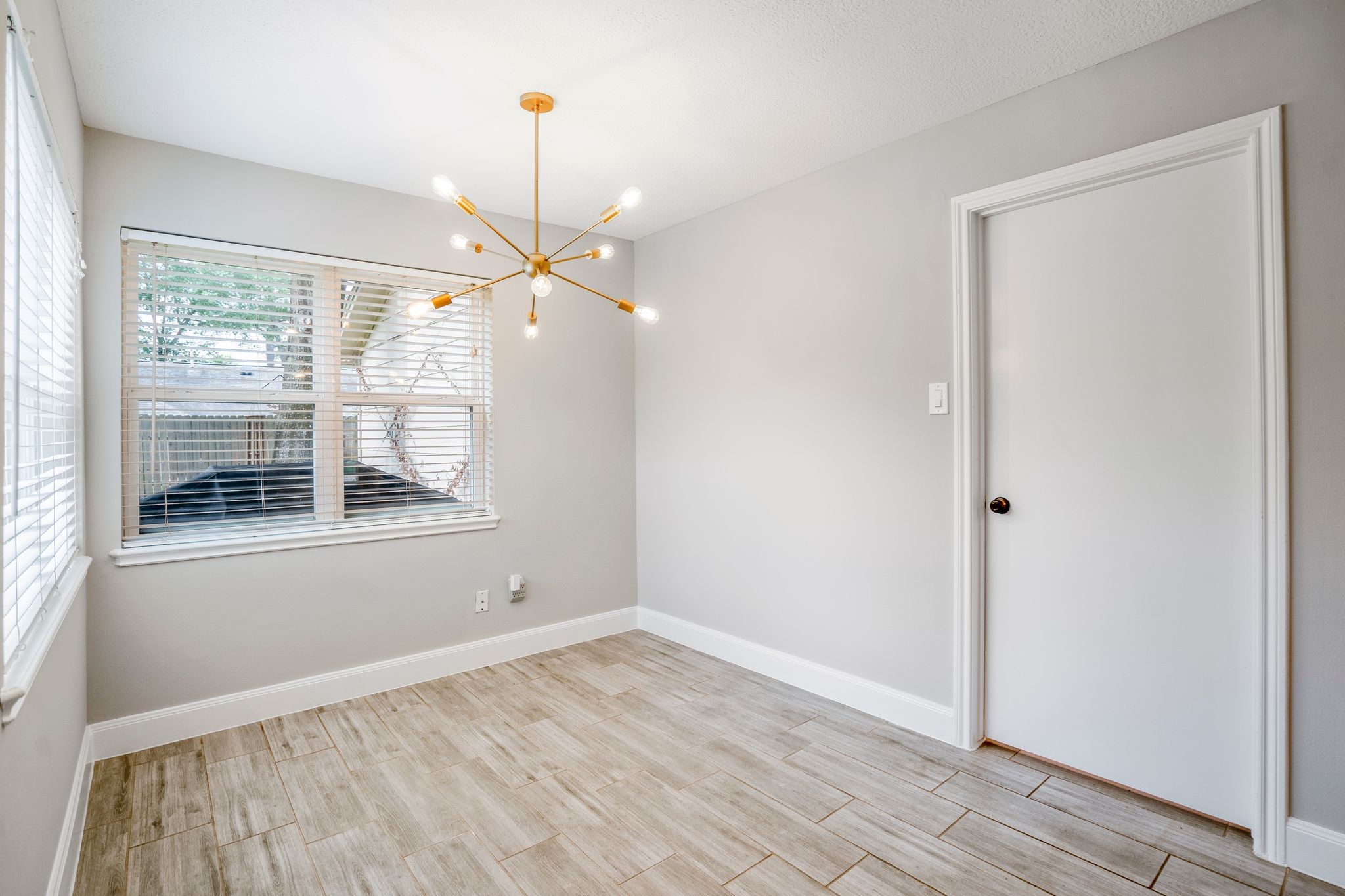 7607 Wycomb Lane Houston, TX 77070 - Photo 12 of 38 an empty room with wooden floor fan and windows