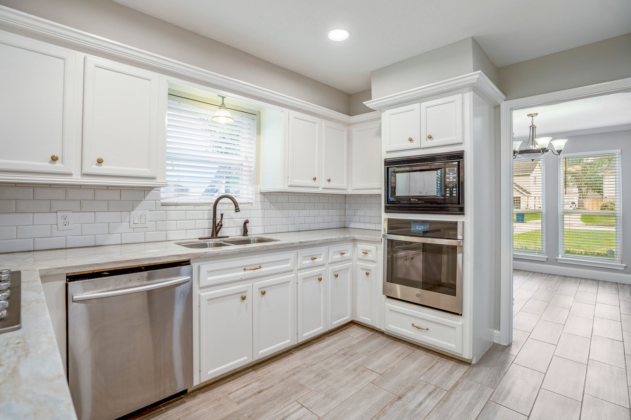 7607 Wycomb Lane Houston, TX 77070 - Photo 15 of 38 a kitchen with white cabinets appliances and a sink