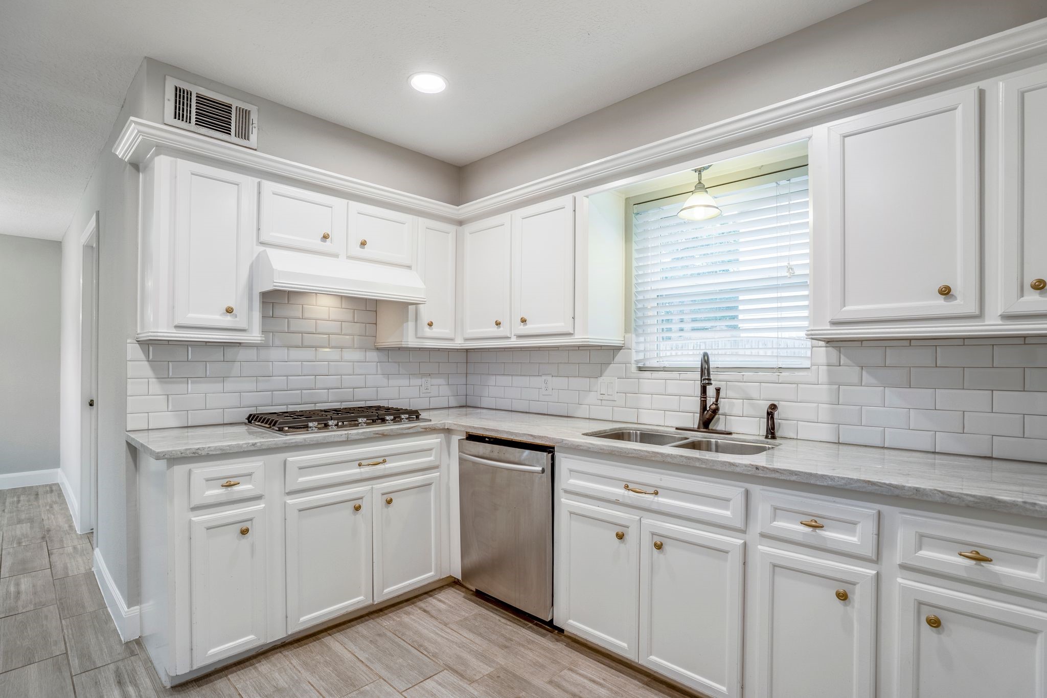 7607 Wycomb Lane Houston, TX 77070 - Photo 16 of 38 a kitchen with granite countertop white cabinets white appliances and a sink