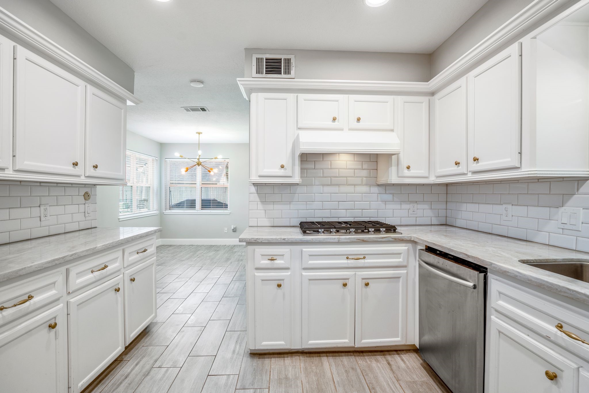 7607 Wycomb Lane Houston, TX 77070 - Photo 17 of 38 a kitchen with granite countertop white cabinets and white appliances