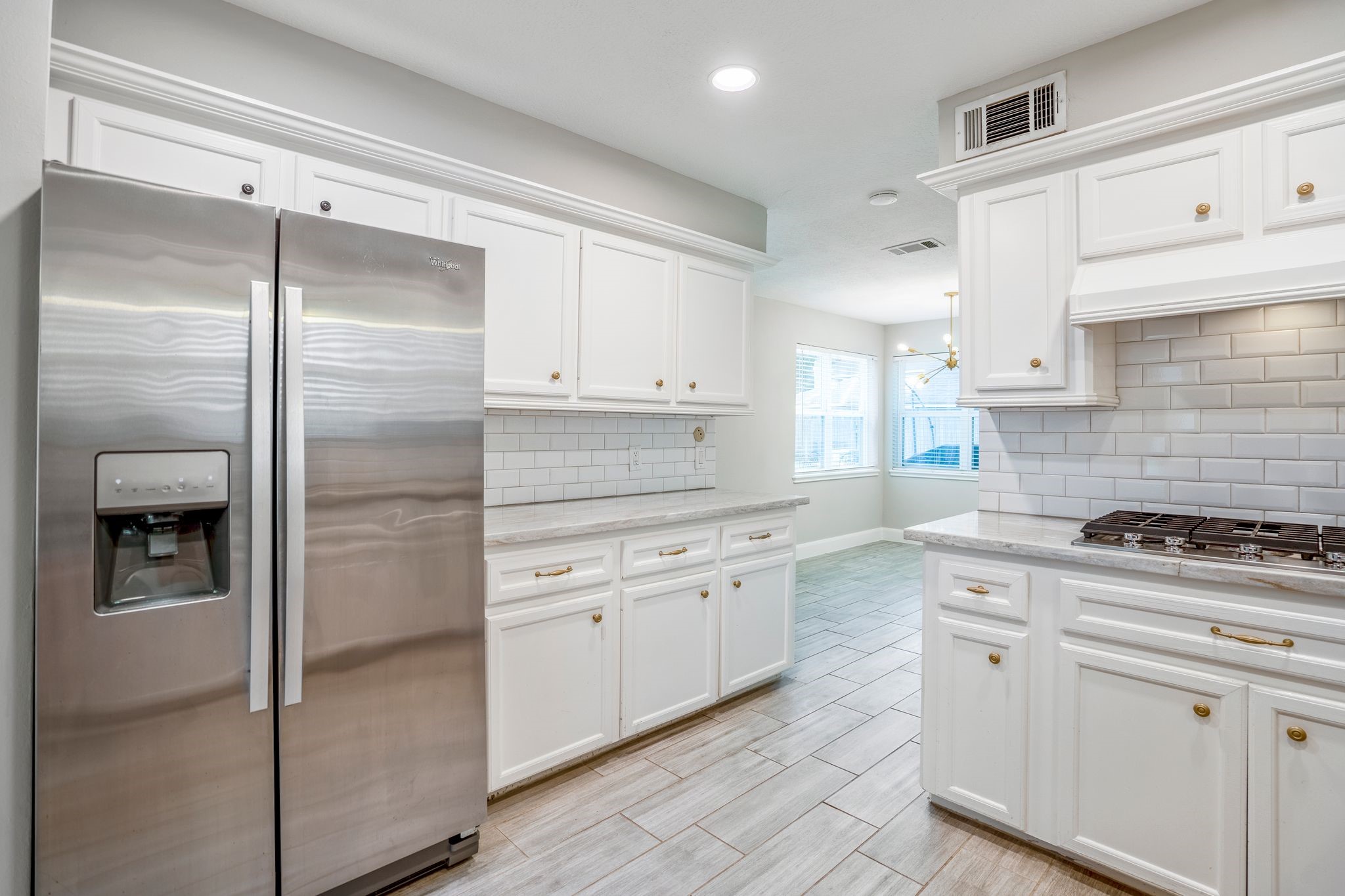 7607 Wycomb Lane Houston, TX 77070 - Photo 18 of 38 a kitchen with white cabinets and appliances
