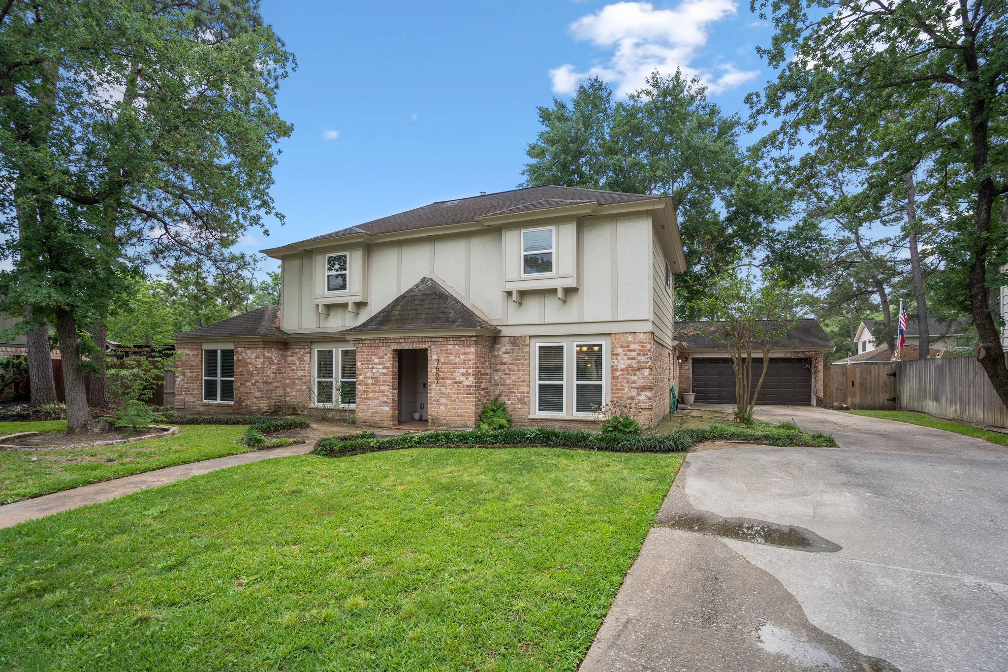 7607 Wycomb Lane Houston, TX 77070 - Photo 2 of 38 a front view of a house with a yard and trees