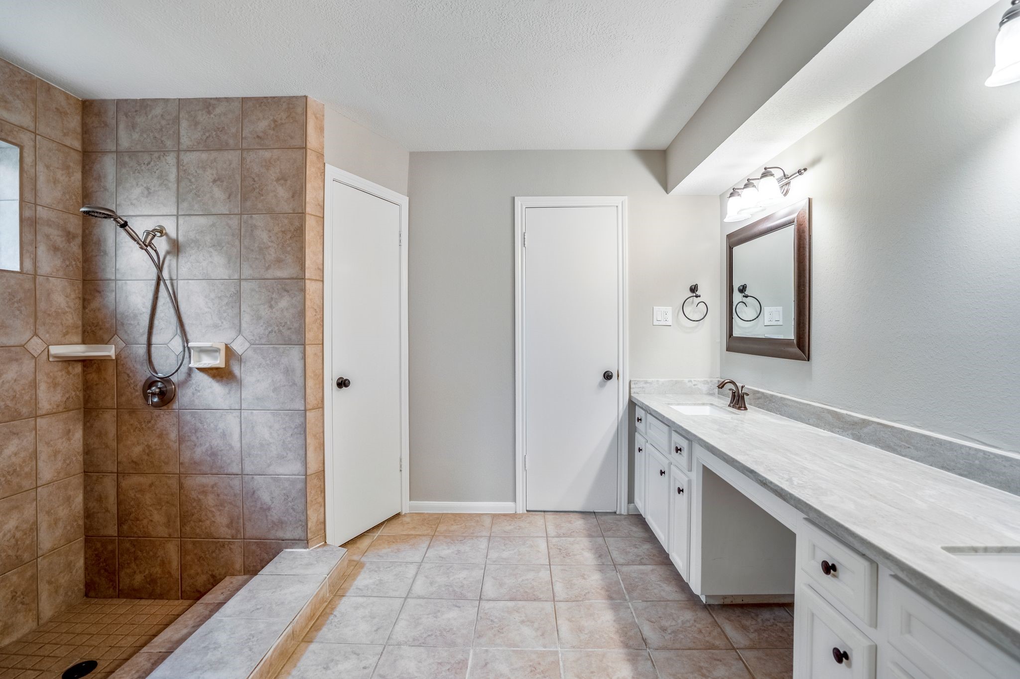 7607 Wycomb Lane Houston, TX 77070 - Photo 21 of 38 a bathroom with a double vanity sink toilet and shower
