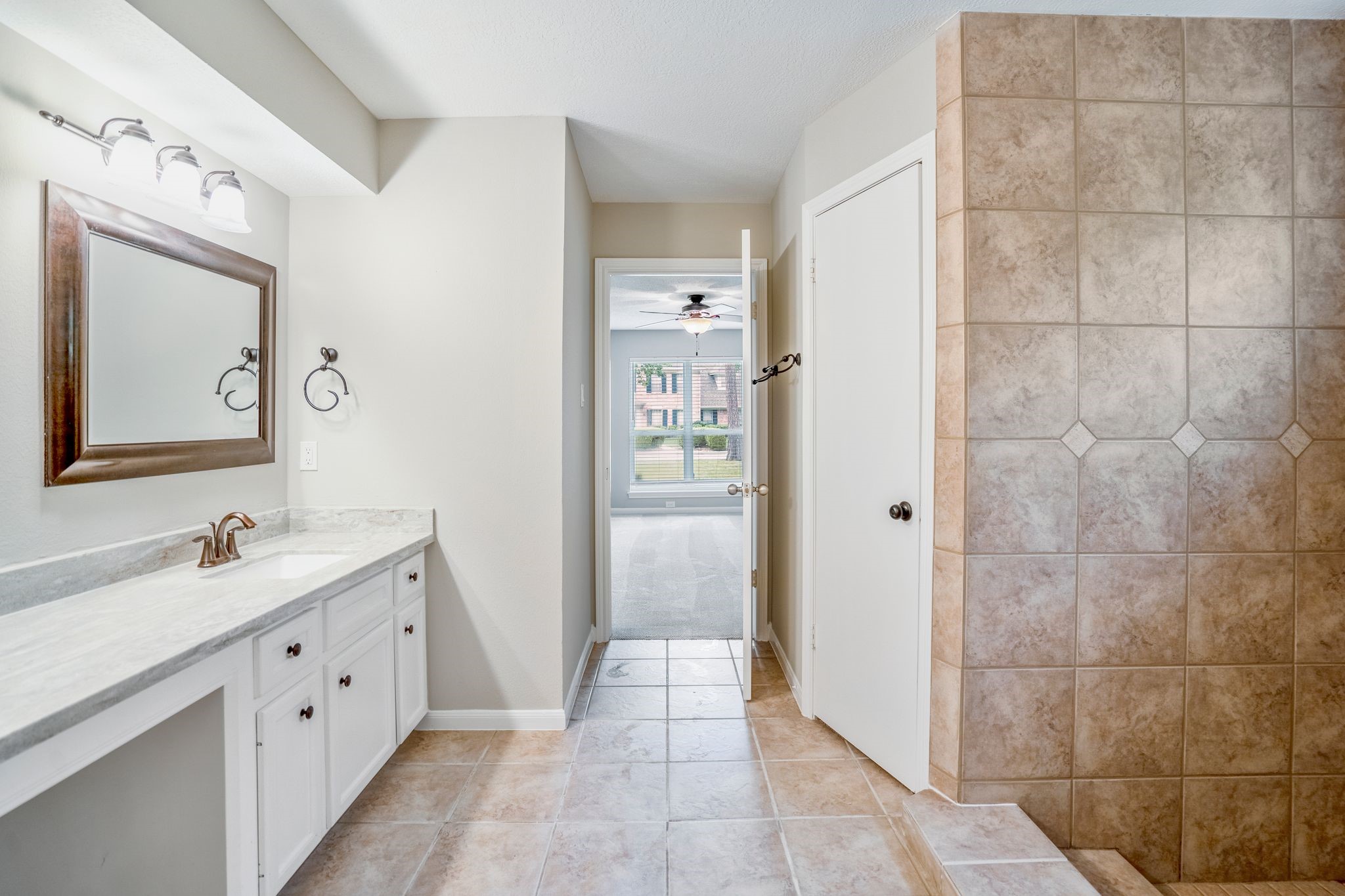 7607 Wycomb Lane Houston, TX 77070 - Photo 23 of 38 a bathroom with a double vanity sink a toilet and shower