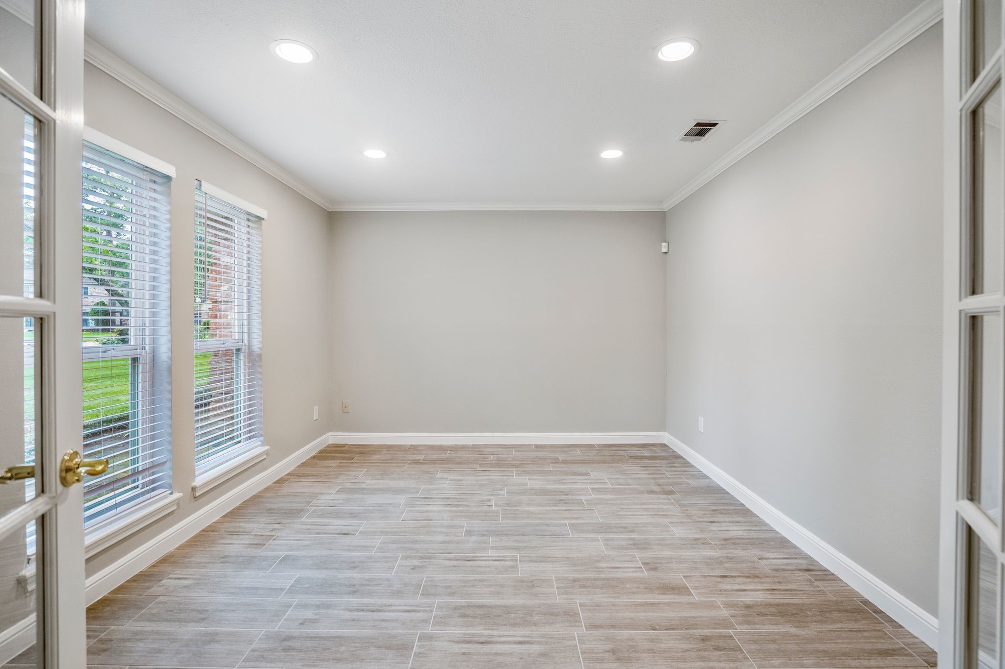 7607 Wycomb Lane Houston, TX 77070 - Photo 5 of 38 a view of an empty room with wooden floor and a window