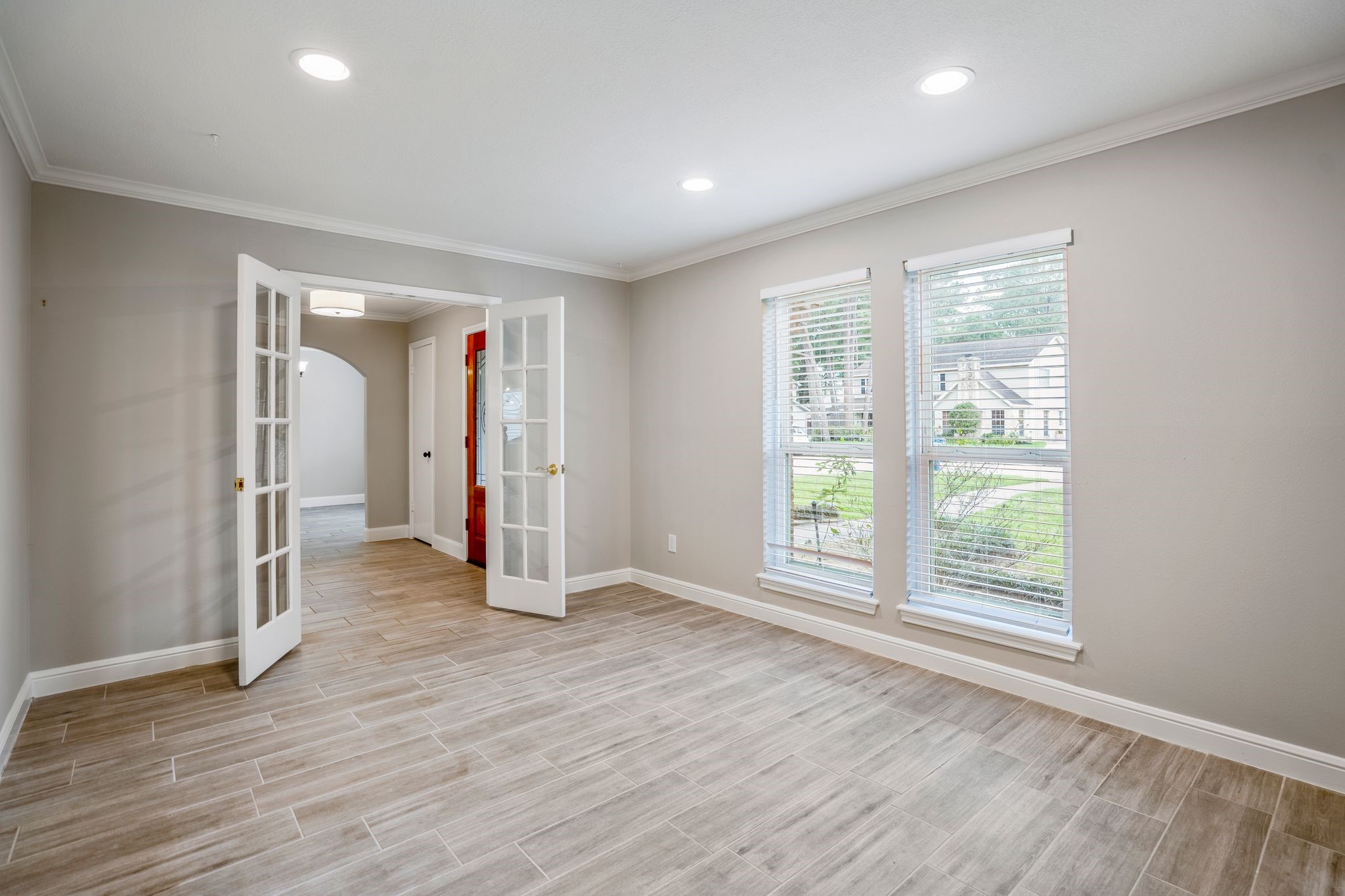7607 Wycomb Lane Houston, TX 77070 - Photo 6 of 38 an empty room with wooden floor and windows